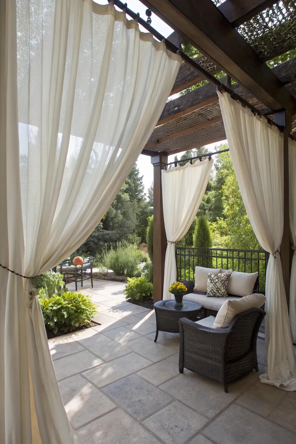 Outdoor curtains provide flexible shade and an airy atmosphere.