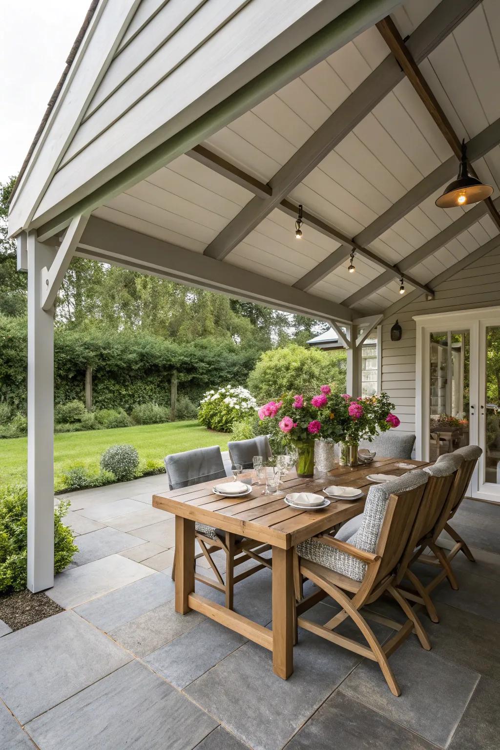 A porch addition with a dining area under a roof extension.
