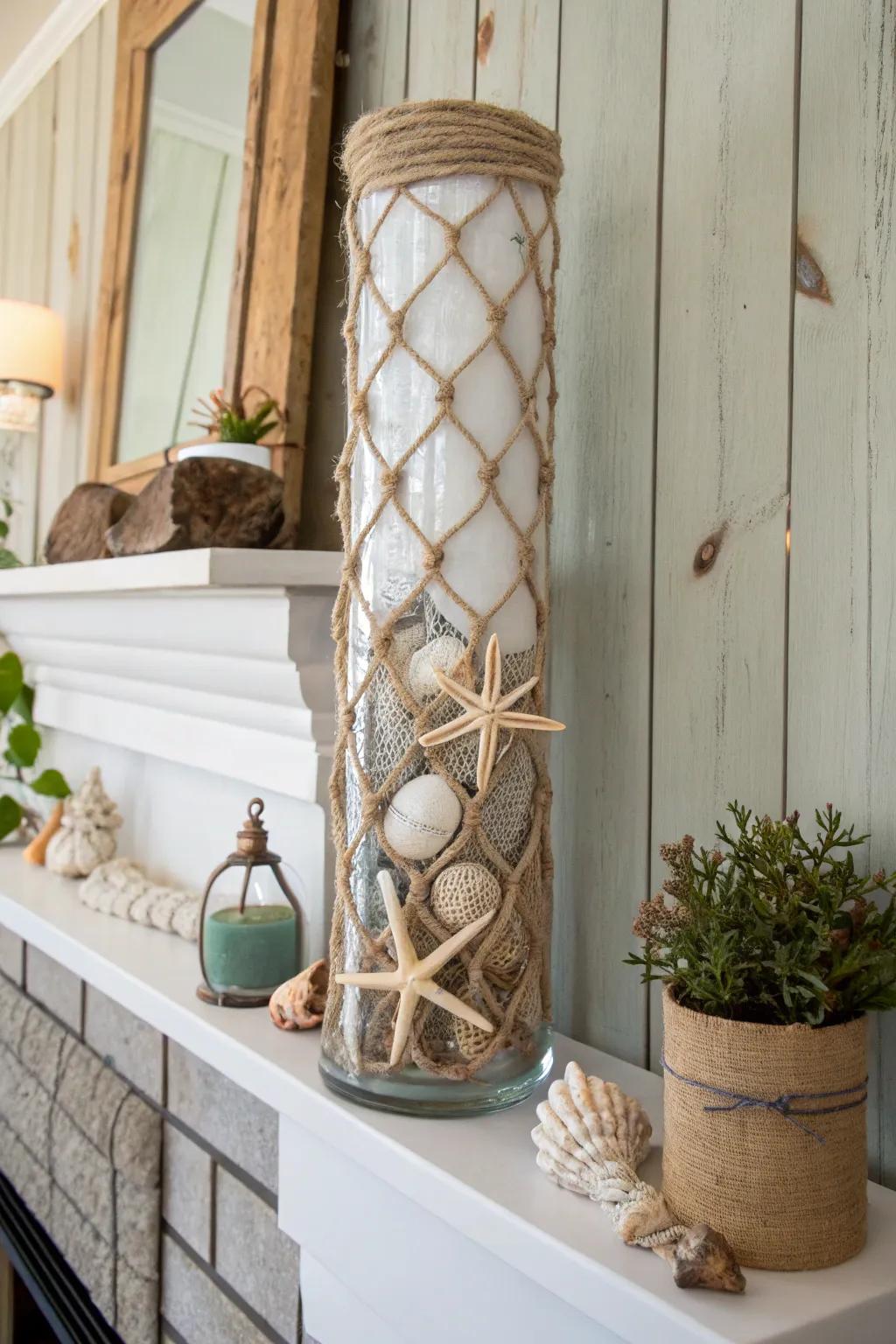 A marine-themed tall glass vase enclosed using rope, adorned with clamshells on a coastal mantle.