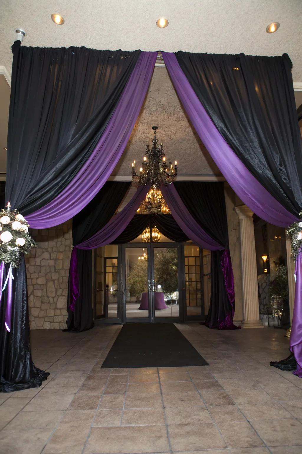 Sophisticated venue entrance decor with midnight and lavender fabric.