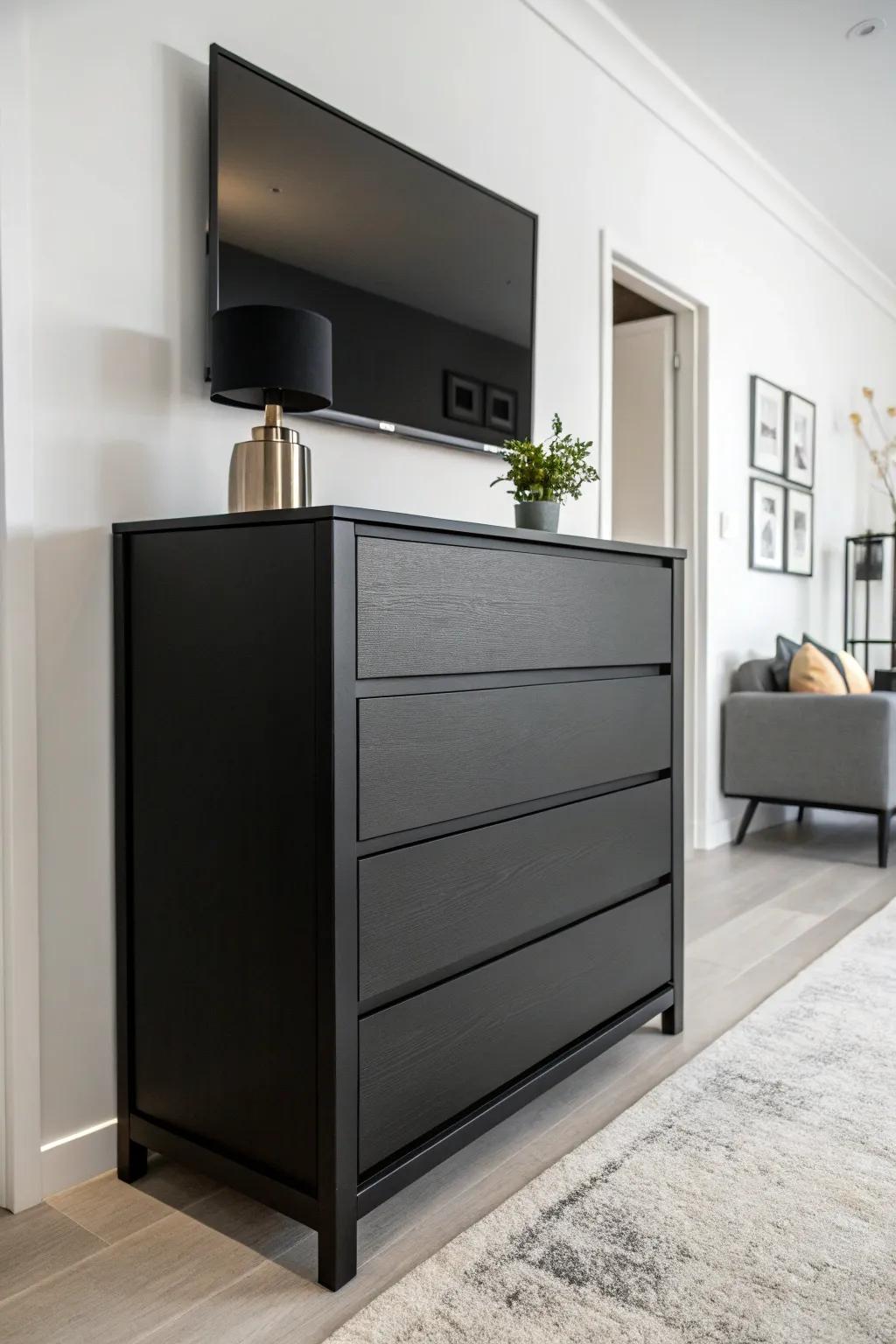 A striking contrast between a black dresser and a light wall.