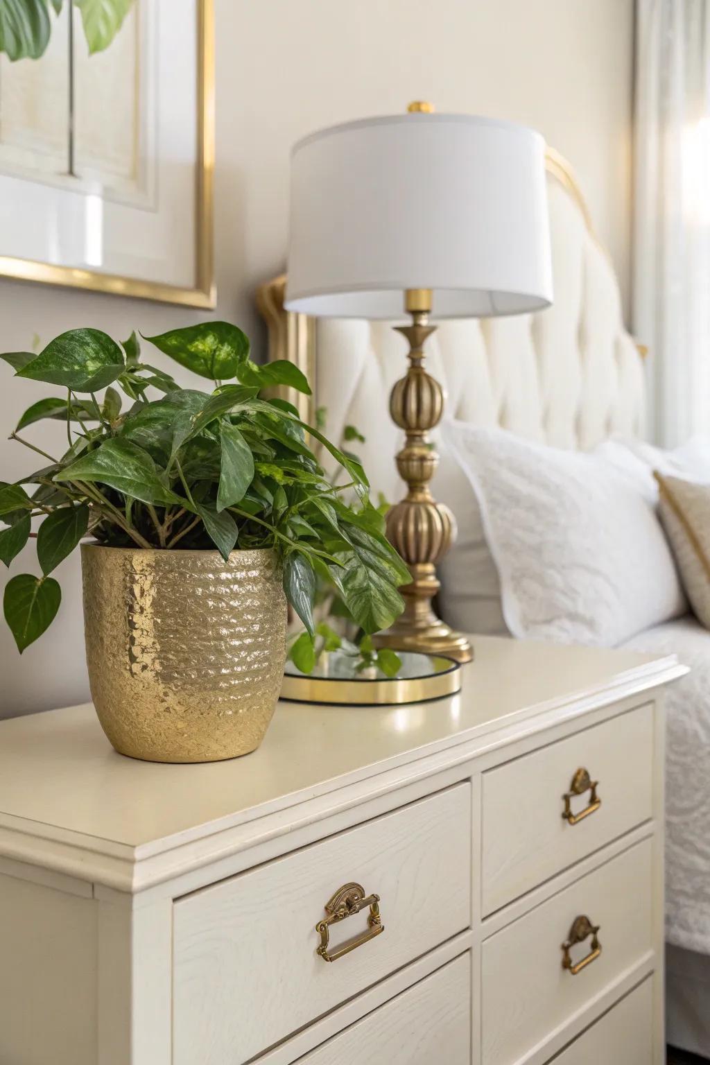 Greenery in a gilded pot delivers a refreshing feature towards the bedroom.