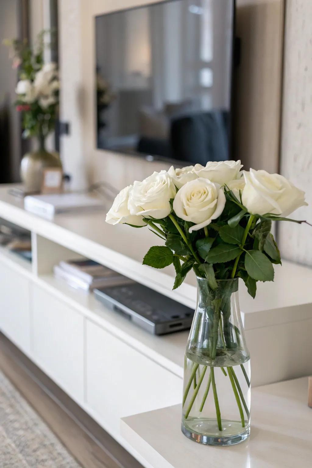 Serenity emanates from minimalistic ivory roses nestled within a crystalline vase.