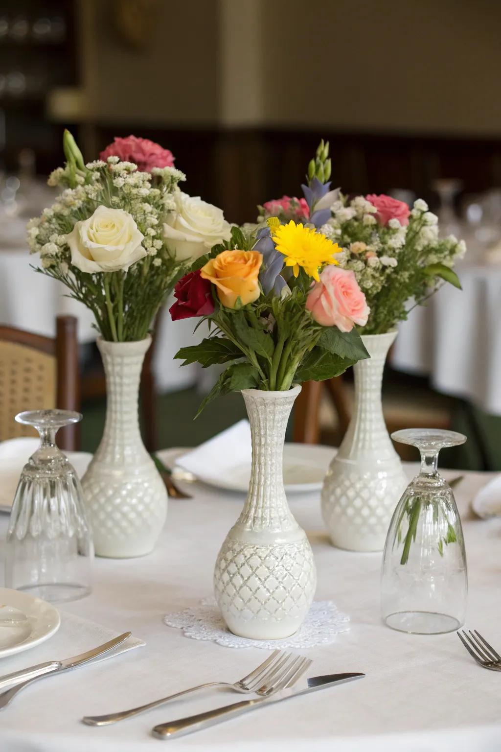 A dining table elegantly arranged with a trio of vases.