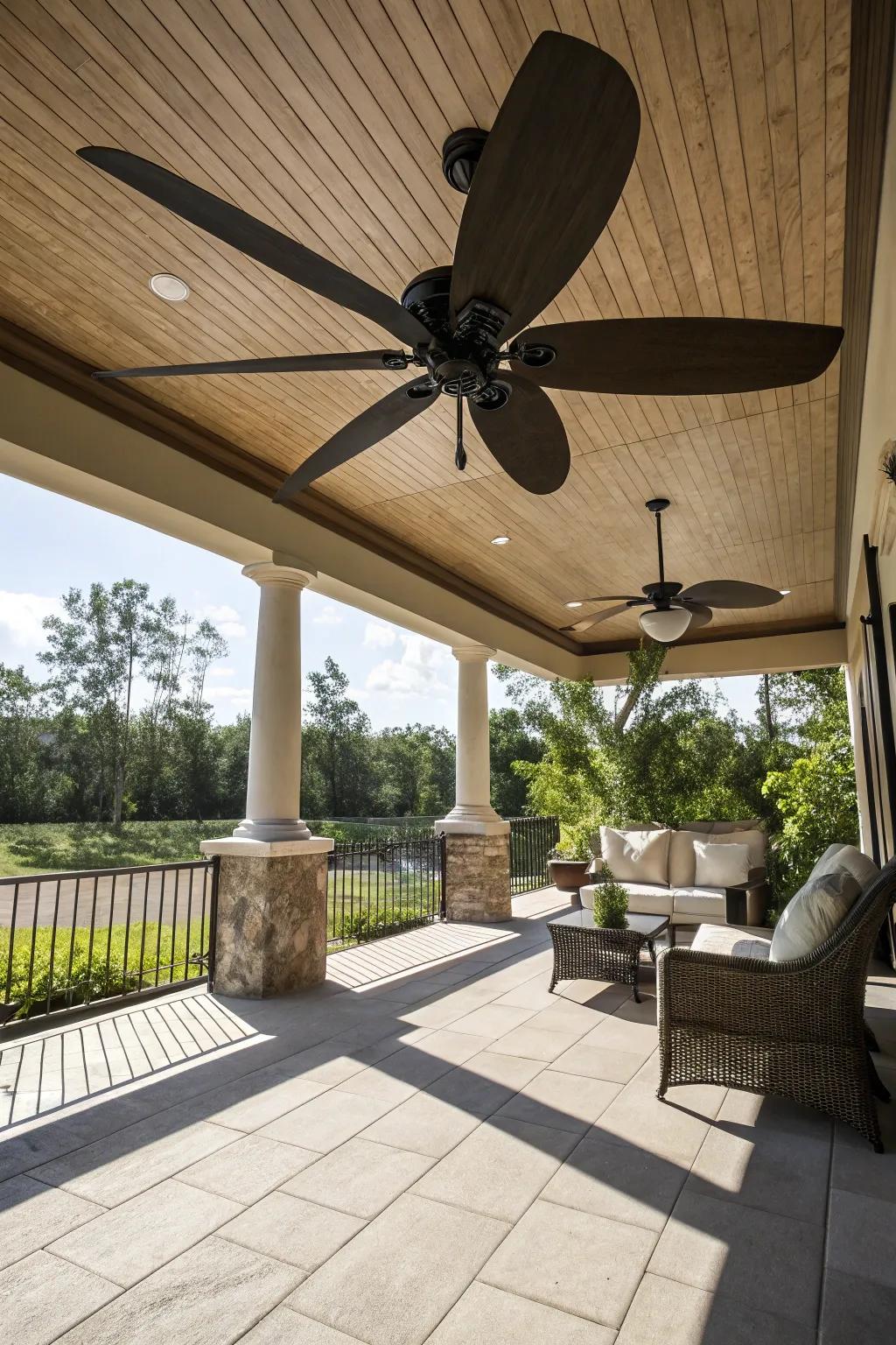 A spacious patio highlighted by a ceiling fan with oversized blades.